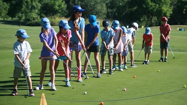 junior golfers practicing their swing