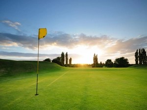 golf flag against the setting sun